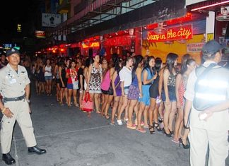 Police raid gives Soi 6 bars night off Bar workers are lined up on Soi 6 so that police can test them for drugs.
